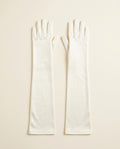 Pair of ivory above-elbow opera gloves on a cream studio backdrop