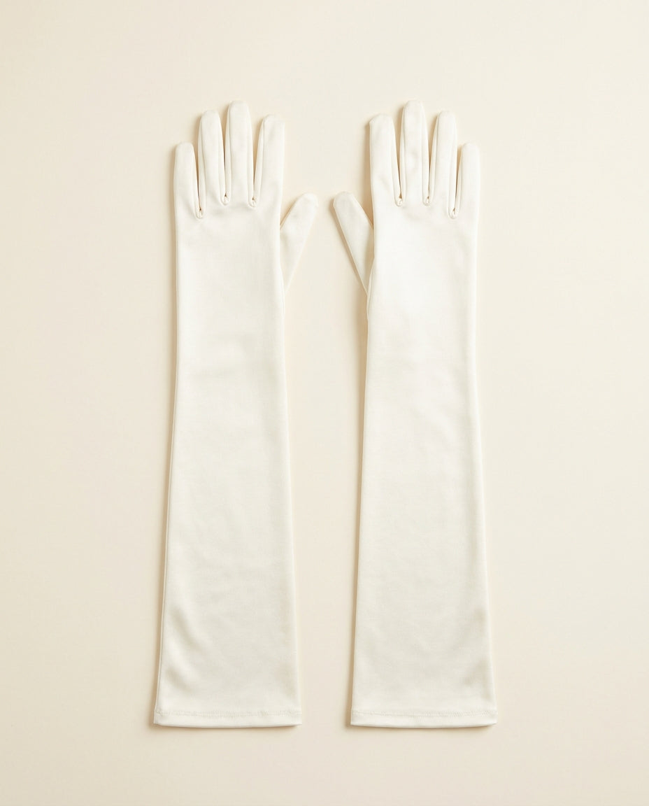 Pair of ivory above-elbow opera gloves on a cream studio backdrop
