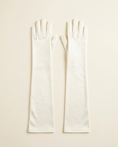 Pair of ivory above-elbow opera gloves on a cream studio backdrop