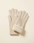 Pair of oatmeal ribbed winter gloves with a fold-back cuff on a cream studio backdrop