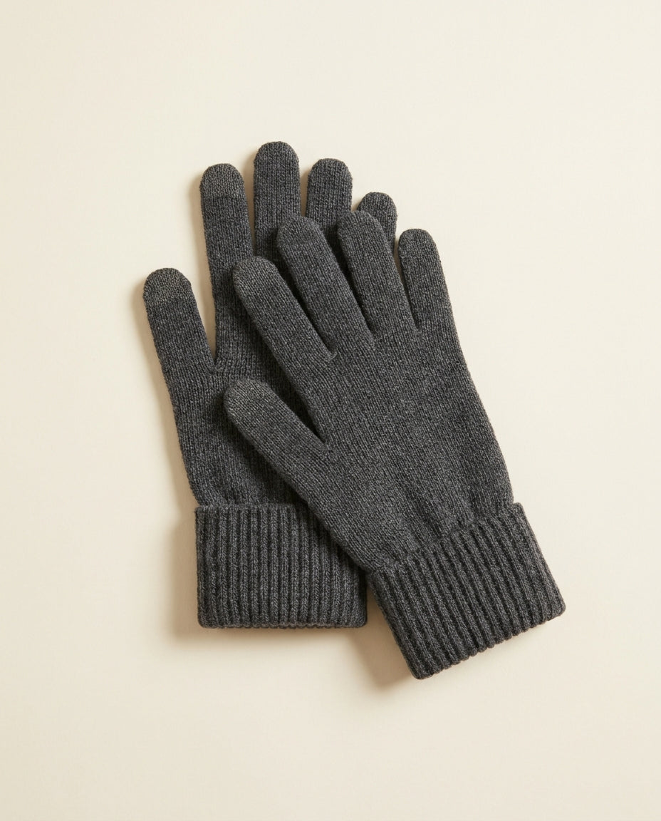 Pair of charcoal ribbed touchscreen gloves laid flat on a cream studio backdrop